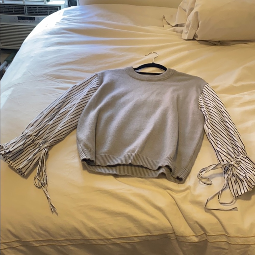 Gray sweater with striped sleeves